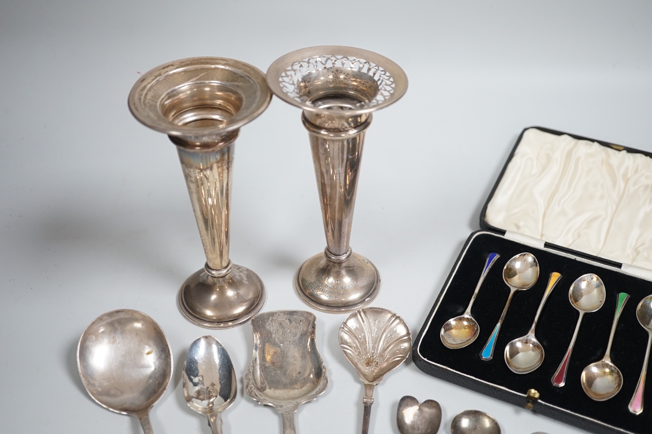 A cased set of six Edwardian silver and enamel teaspoons, William Hair Haseler, Birmingham,1913 and a collection of silver spoons and two silver mounted specimen vases.